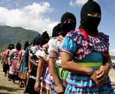 Zapatista women enter the auditorium in a single file